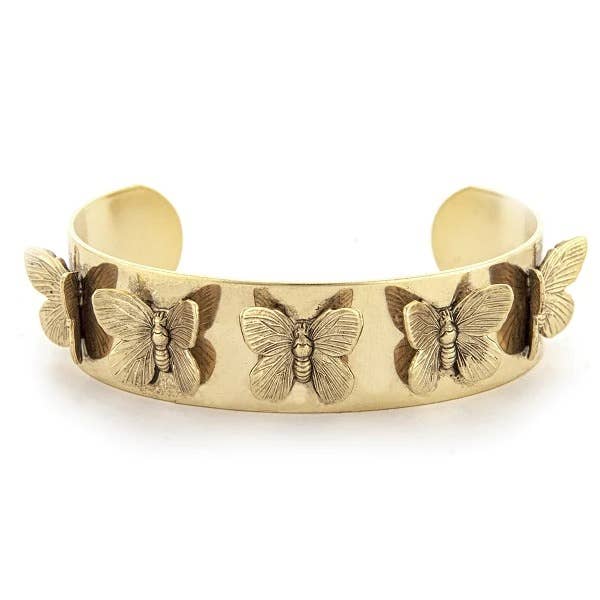 A gold-colored metal cuff bracelet adorned with a series of butterfly designs on the front.