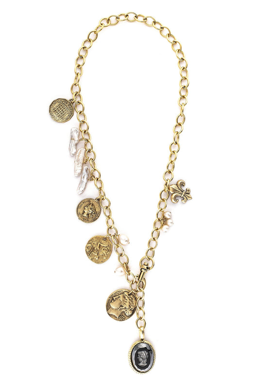 A gold-plated necklace with vintage inspired coins, fresh water pearls, and a fleur-de-lis charm.