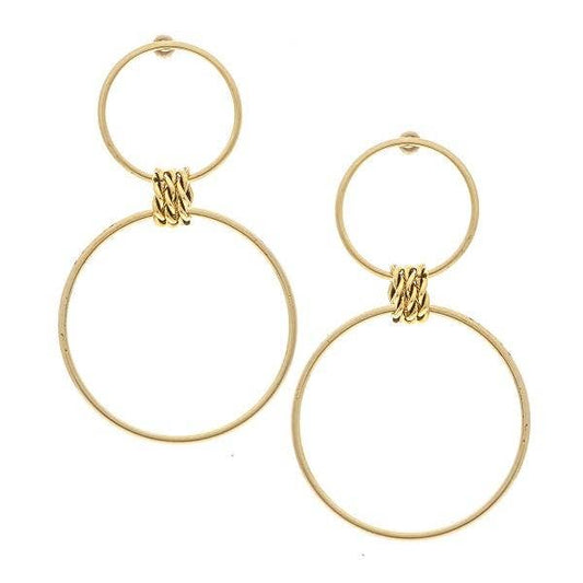 A pair of gold-colored double hoop earrings against a white background.