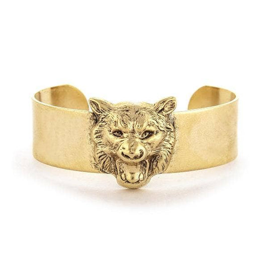 A gold-colored bracelet with a single tiger face design on a medium cuff.