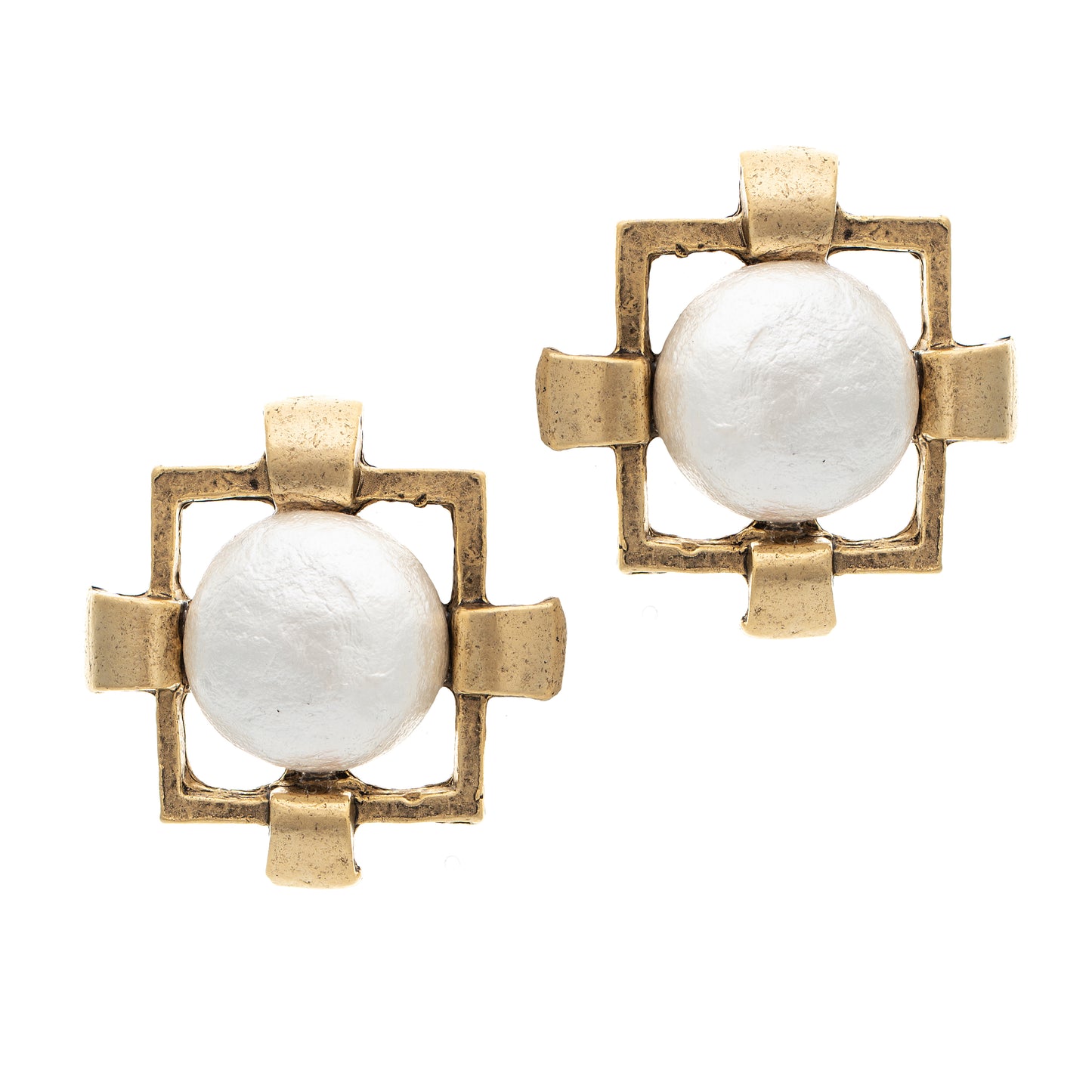 Pair of earrings with gold frames and white central stones on a white background