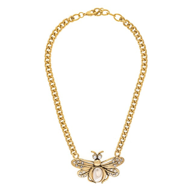 Gold chain necklace with a bee pendant on a white background
