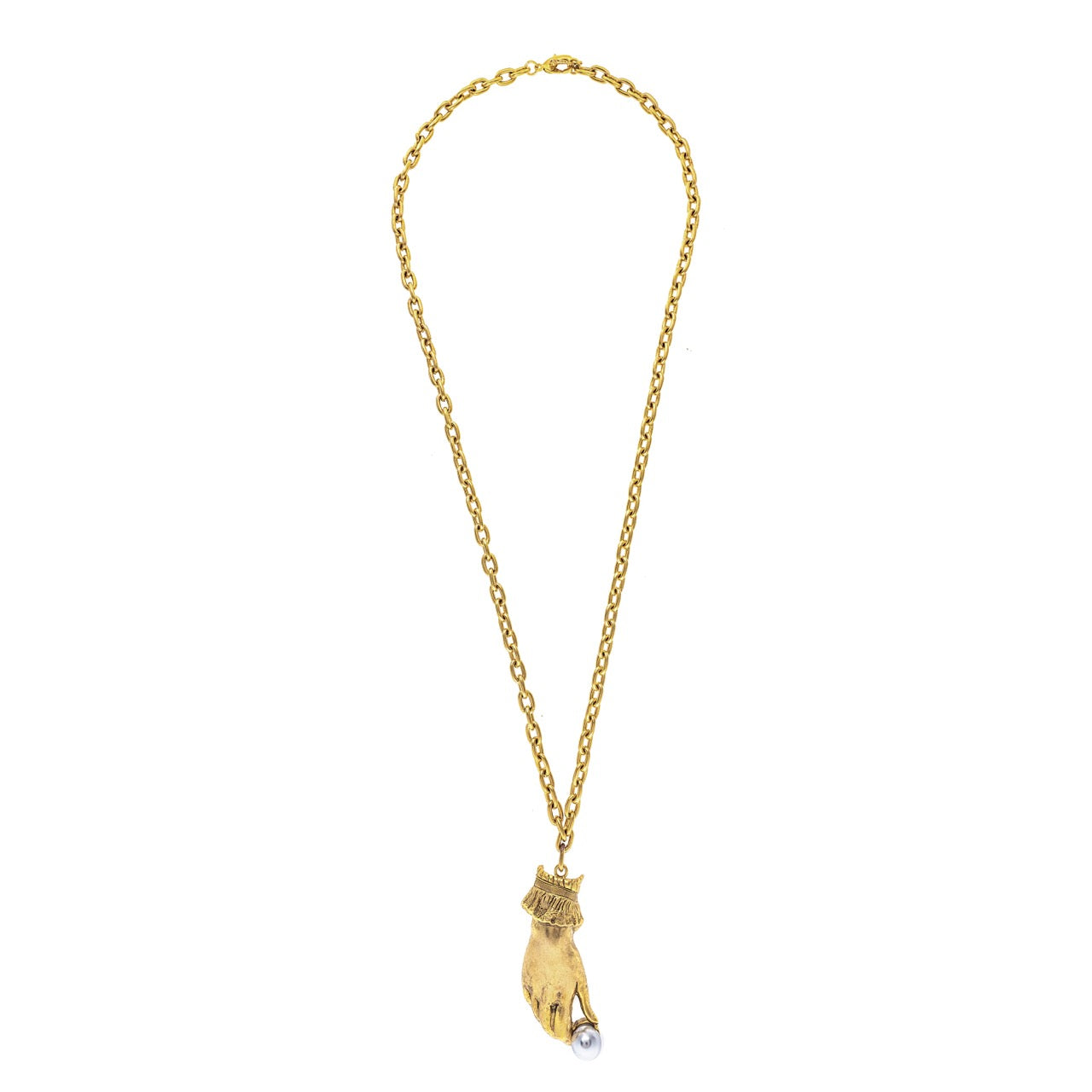 Gold necklace with a hand holding a pearl pendant on a white background