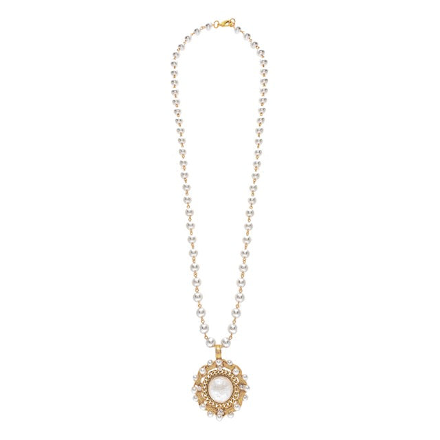Gold necklace with a pendant on a white background