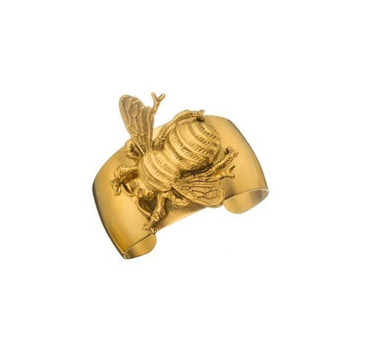 A gold-colored bee cuff bracelet with intricate detailing, displayed against a plain background.