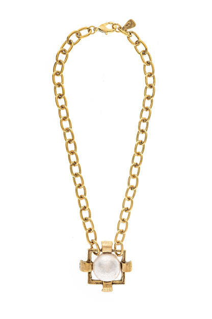A gold-plated necklace with a square-shaped pendant at the center, attached to a gold chain.