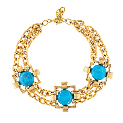 A multi-layered gold-plated necklace with white tri-colored accents, featuring a brass construction.