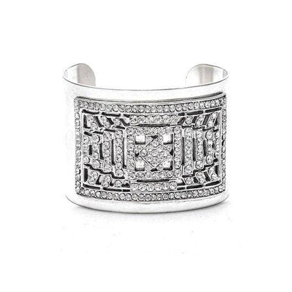 A gold-colored chunky bracelet adorned with intricate designs and detailed with swarovski crystals, displayed against a white background.