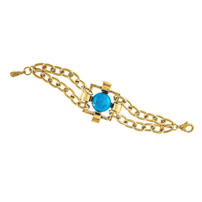 A gold-plated bracelet with a central blue stone and intricate chain design.
