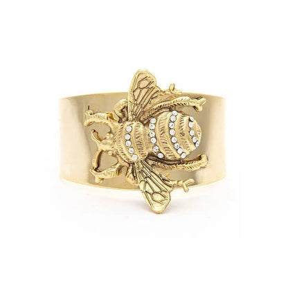 A gold-colored cuff bracelet featuring a detailed multi-dimensional bee design with Swarovski crystal throughout.