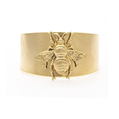 A gold-colored cuff bracelet featuring a large bee design, crafted from 22K antique gold plated metal.