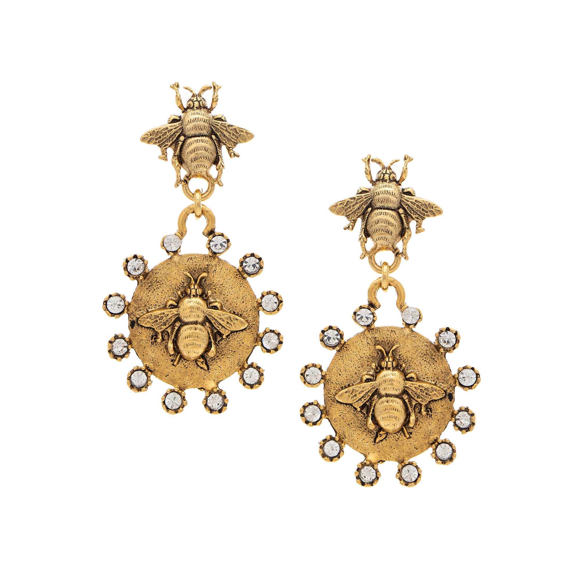 Gold bee earrings with circular designs and small stones on a white background