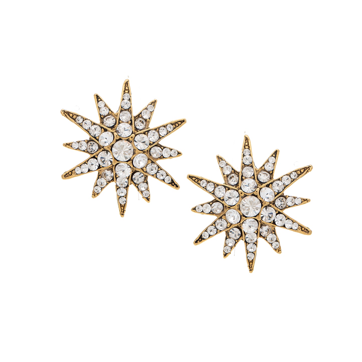 Pair of star-shaped earrings with gold and crystal details on a white background
