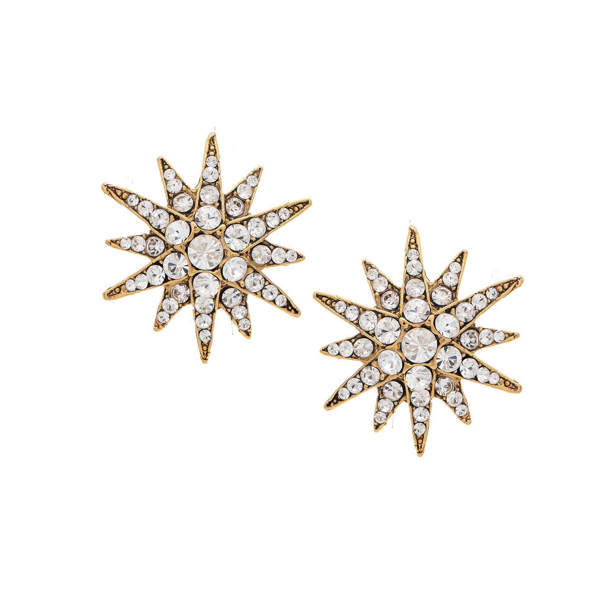 Pair of star-shaped earrings with gold and crystal details on a white background