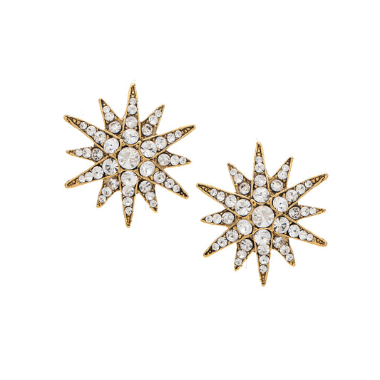 Pair of star-shaped earrings with gold and crystal details on a white background