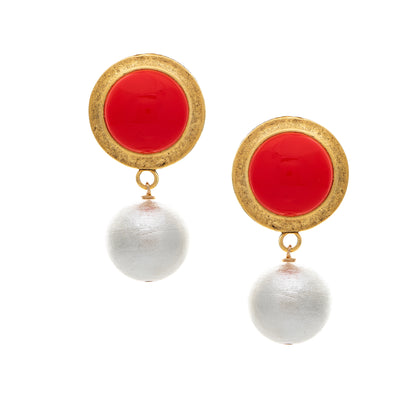 Pair of earrings with red circular tops and white spherical bottoms on a white background