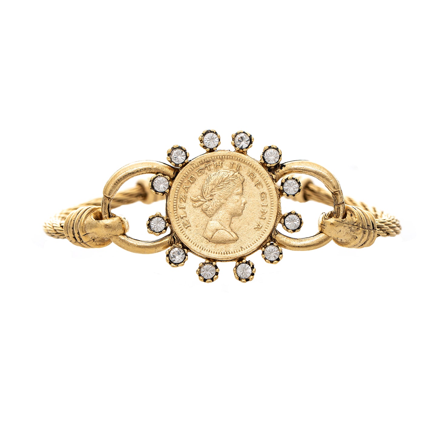 Gold brooch with coin and gemstone design on a white background