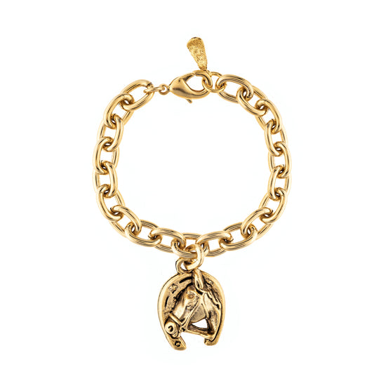 Gold chain bracelet with a horse head charm on a white background