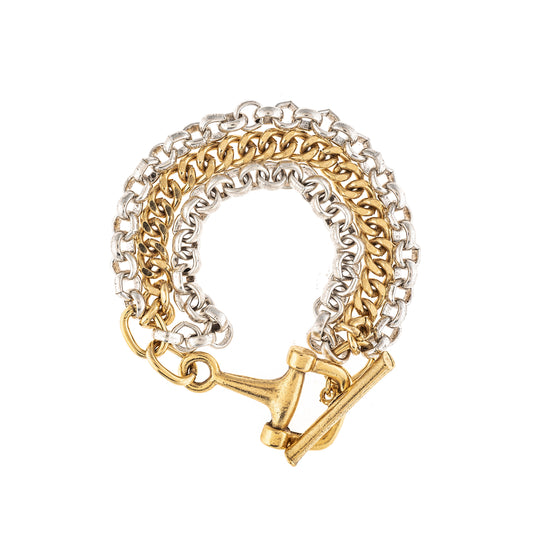 Gold and silver chain bracelet with a horse bit clasp on a white background