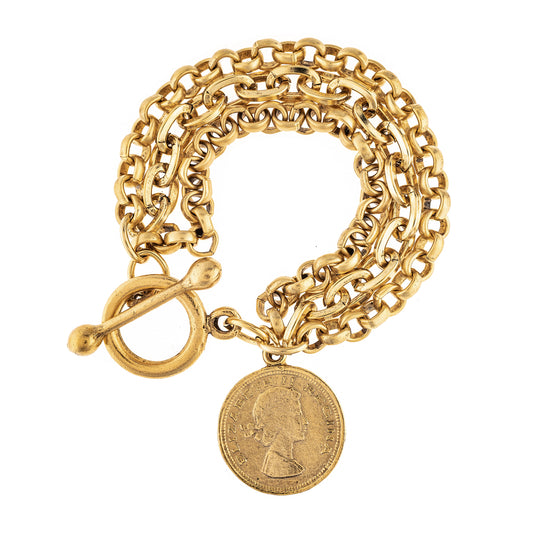 Gold chain bracelet with a coin charm on a white background