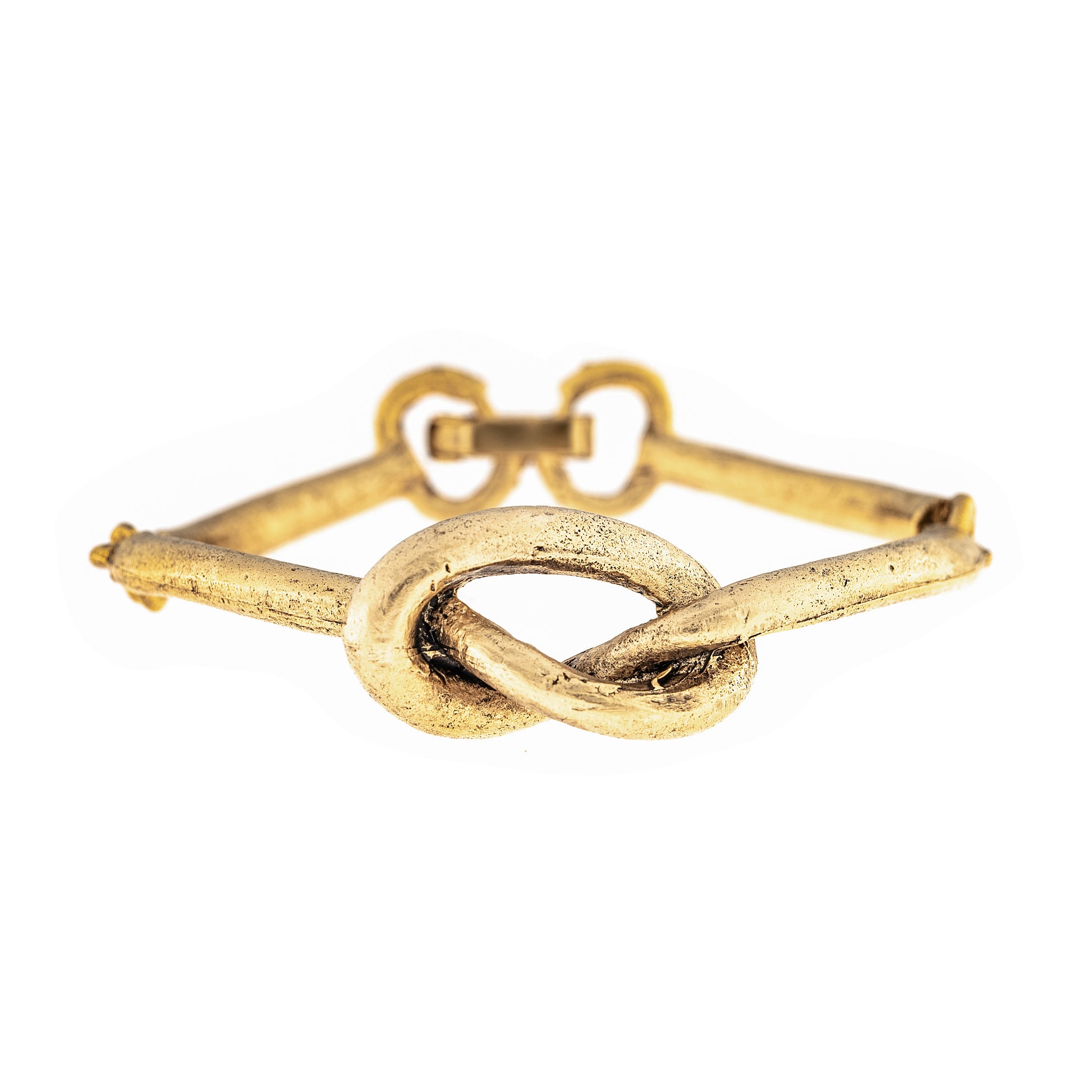 Gold bracelet with a knot design on a white background