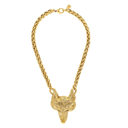 Gold chain necklace with a fox head pendant on a white background