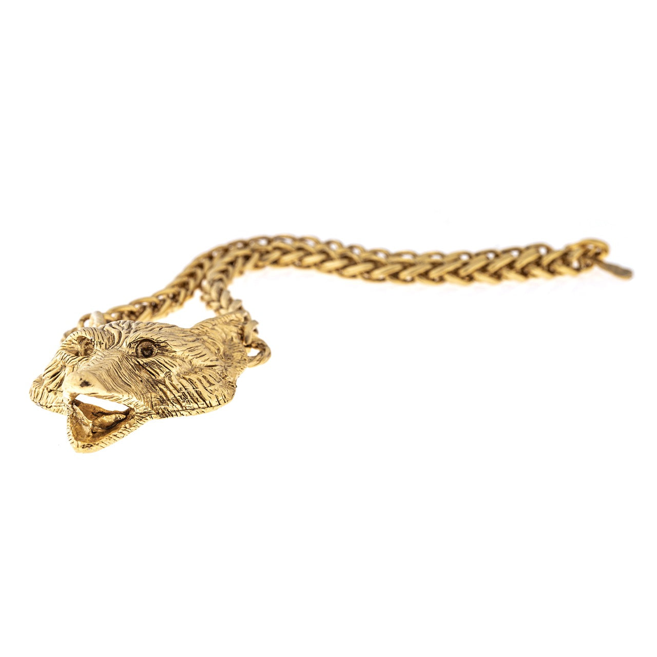 Gold chain necklace with a bear head pendant on a white background