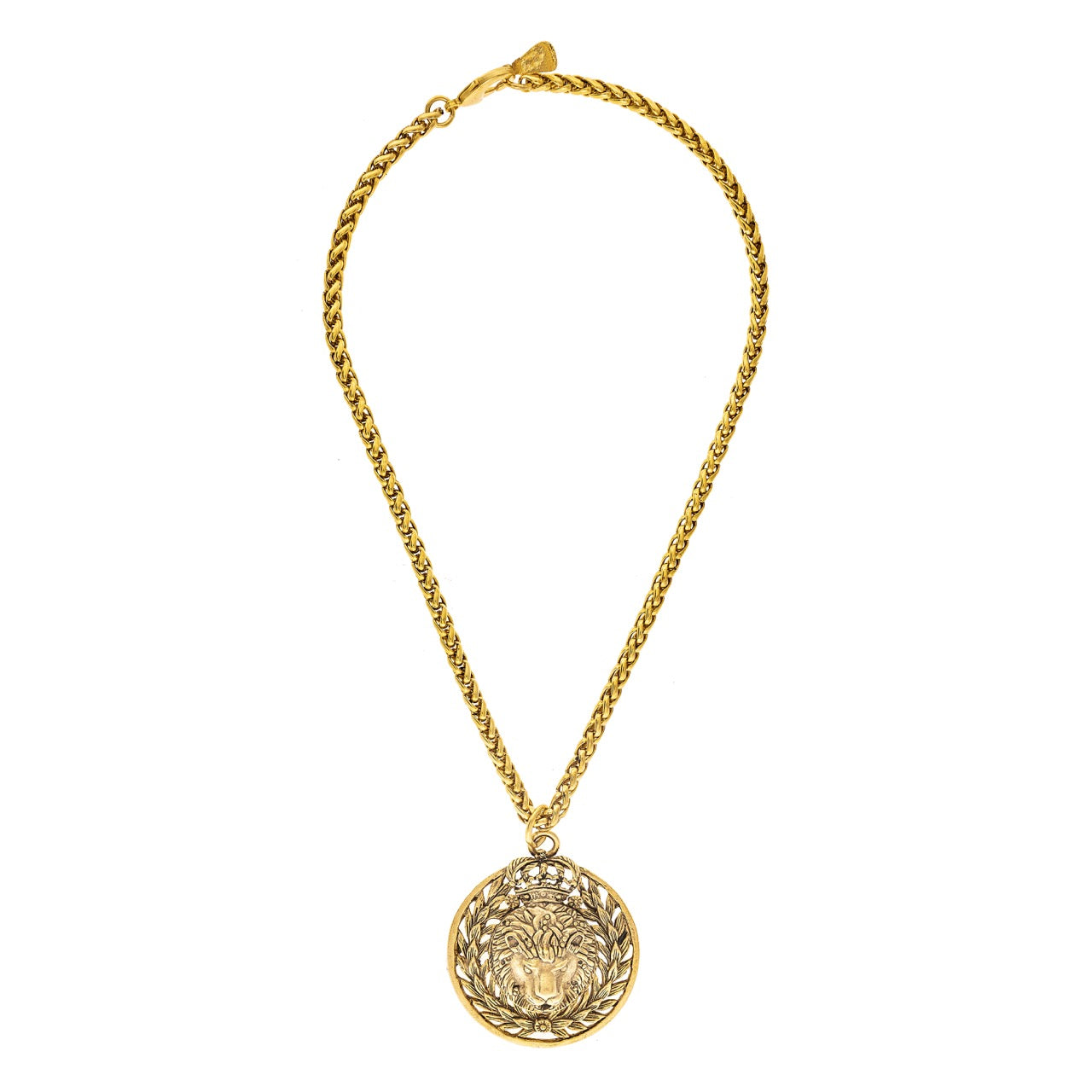 Gold necklace with a round pendant on a white background