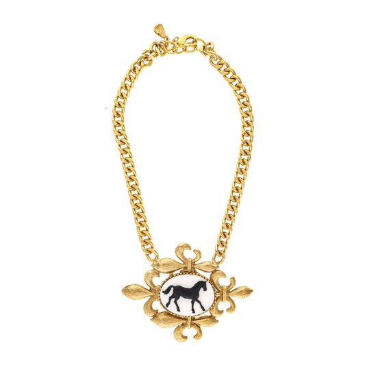 Gold chain necklace with a black and white pendant featuring a horse on a white background