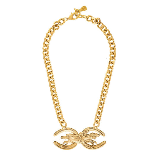 Gold chain necklace with a bow-shaped pendant on a white background