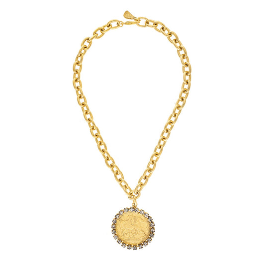 Gold chain necklace with a round pendant on a white background