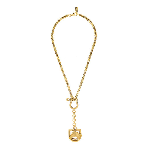 Gold necklace with a unique pendant on a white background