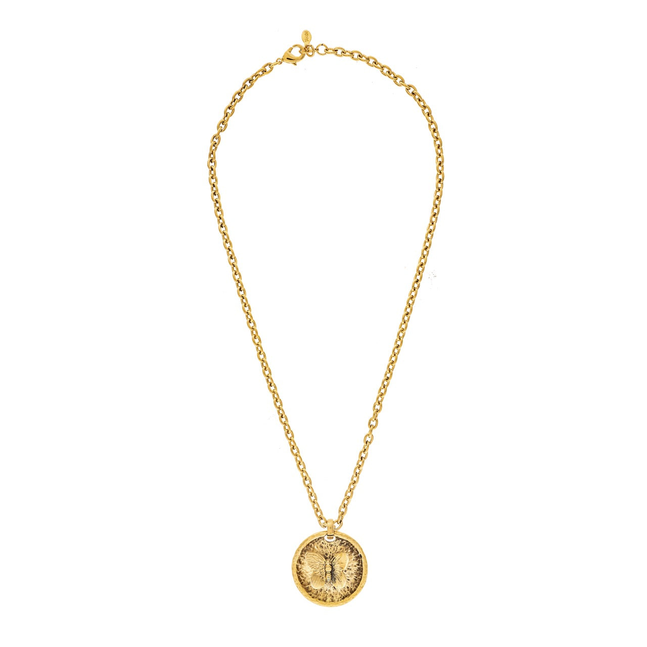 Gold necklace with a round pendant on a white background