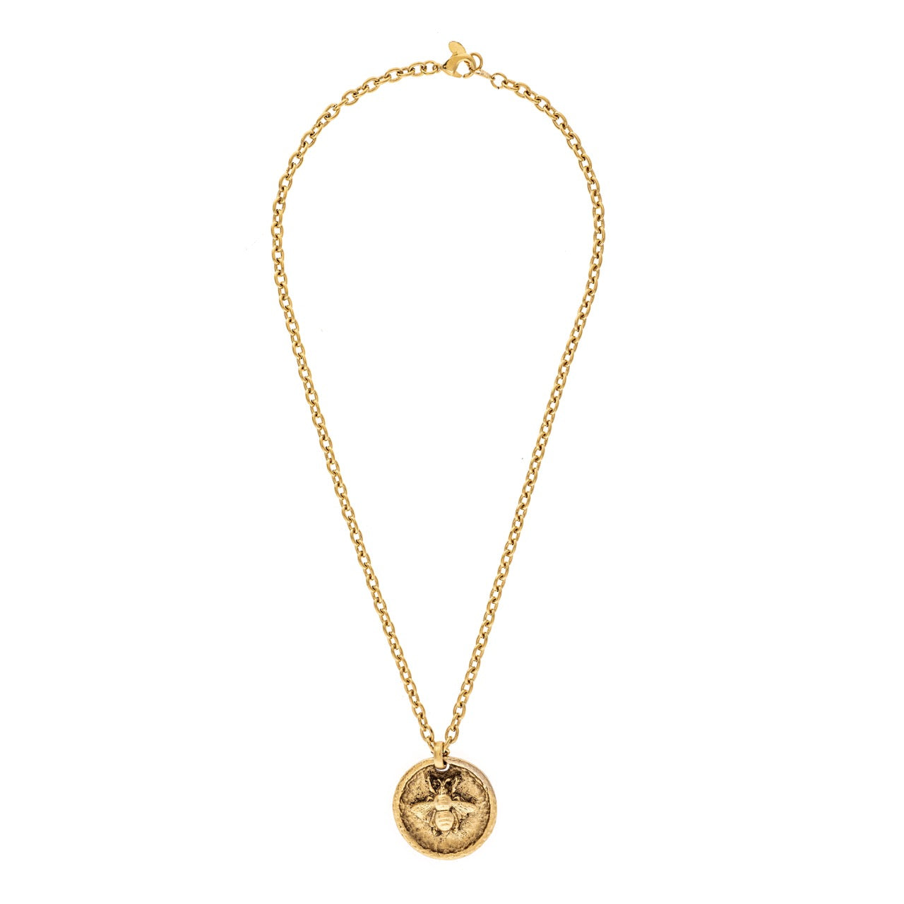 Gold necklace with a circular pendant on a white background