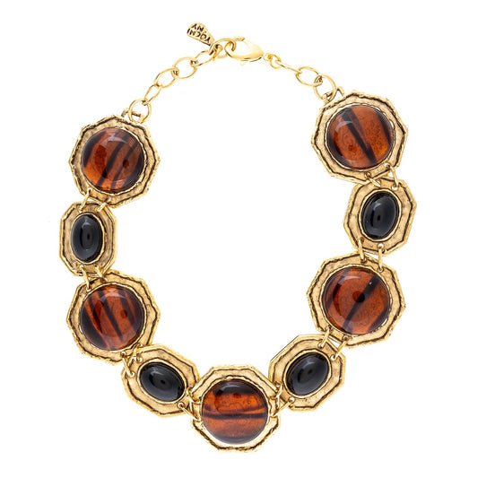 Gold bracelet with hexagonal beads featuring brown and black patterns on a white background