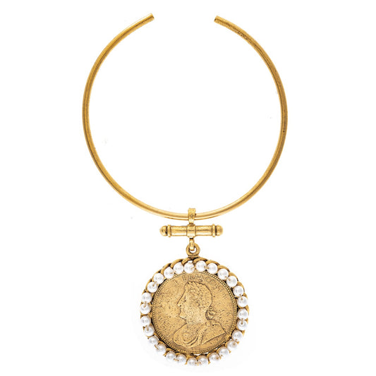Gold necklace with a coin pendant and pearl accents on a white background