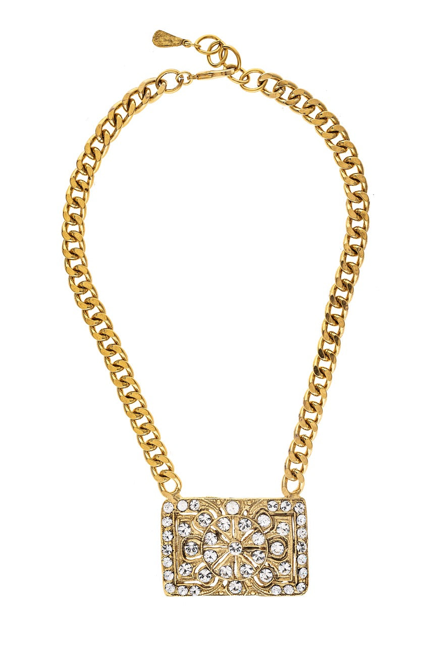 Gold chain necklace with a rectangular pendant on a white background
