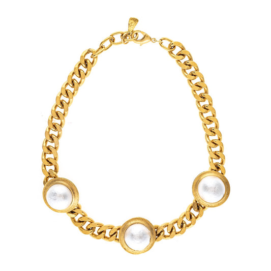Gold chain bracelet with pearl-like beads on a white background
