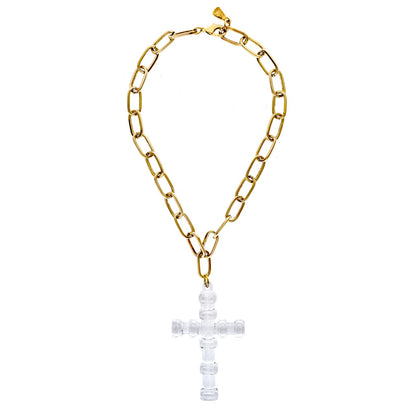 Gold chain necklace with a clear cross pendant on a white background
