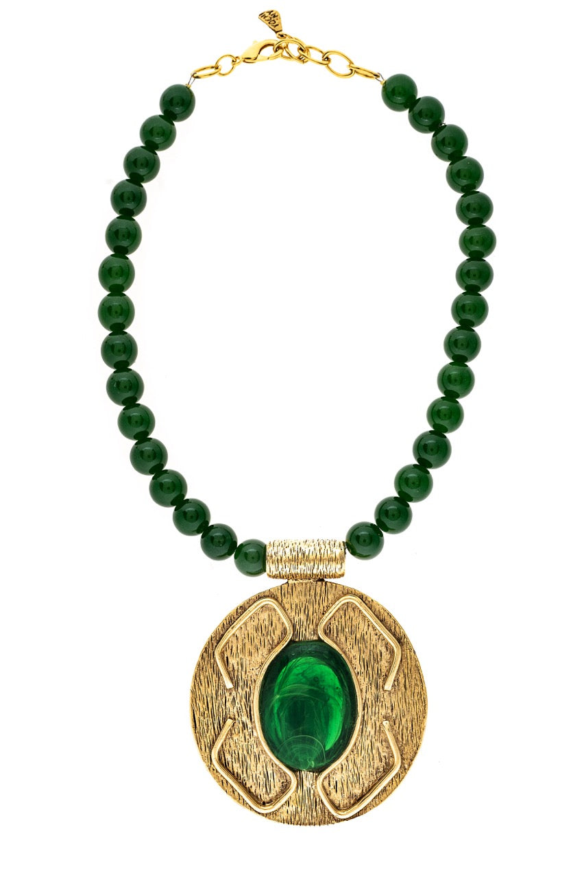 Necklace with green beads and a gold pendant on a white background