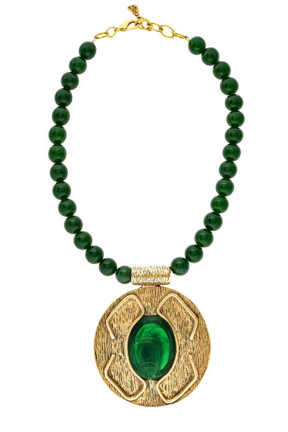 Necklace with green beads and a gold pendant on a white background