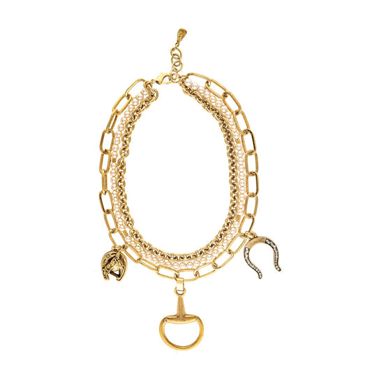 Gold chain necklace with charms on a white background
