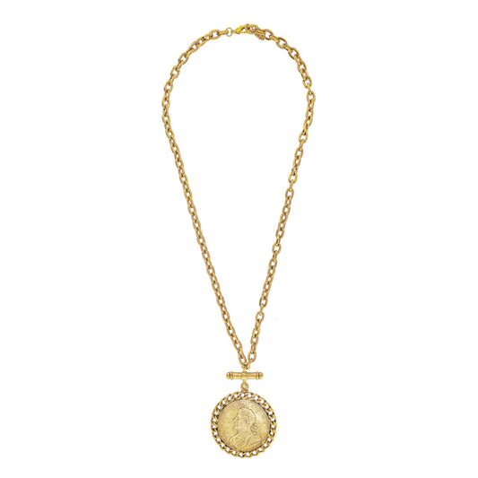 Gold necklace with a round pendant on a white background