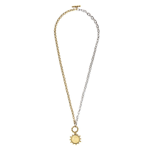 Two-tone gold and silver necklace with a sun pendant on a white background