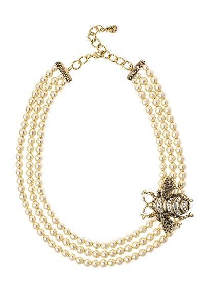 A three-strand Italian glass pearl necklace with gold-colored metal bee and crystal embellishments at the clasp.