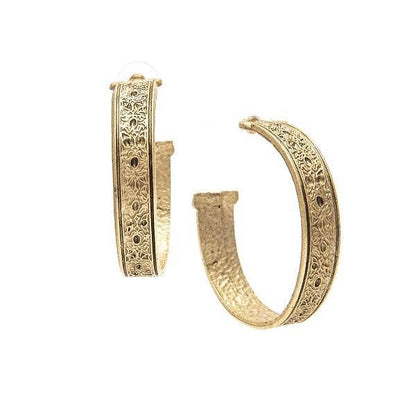 A pair of gold hoop earrings with hand crafted etchings, displayed against a white background.
