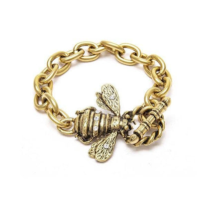 A gold-colored bracelet with a bee charm attached to a chain.